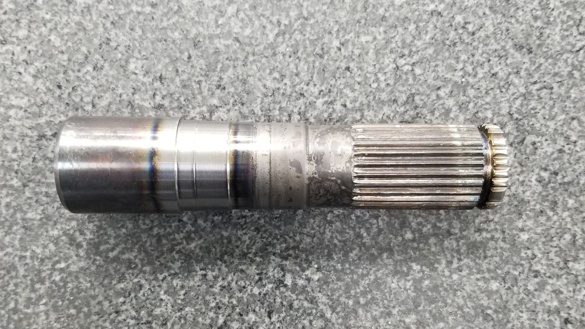 Machined automotive axle stub shaft with turned diameters and an external spline